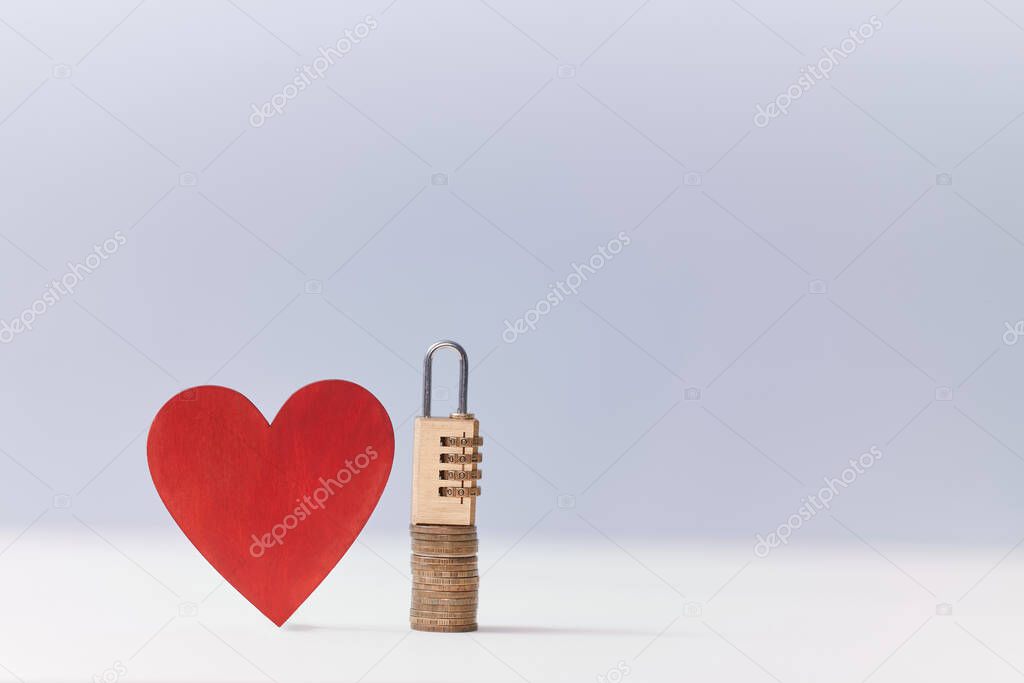 Blank red heart and stack of coins, combination lock on top. Love vs money mockup. Key to heart and success, copy space