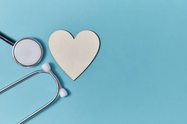 Heart disease and health mockup. White blank heart and stethoscope on blue background. Medicine and healthcare concept