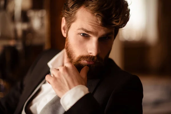 Close up portrait of confident businessman has thick ginger beard and mustache, dressed formally, being self assured in his success, waits for business partner. People, work, job, occupation concept