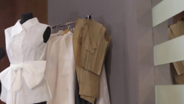 Tailor and mannequin at fashion studio. Tailor working at Studio. Taking measures. White mannequin in fron of the light — Stock Video