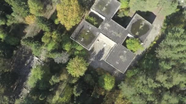 Survoler le bâtiment au milieu de la forêt. Relevé aérien de l'extérieur de l'hôpital abandonné.Une vue solitaire du bâtiment.Le bâtiment a été abandonné il y a près de vingt ans, mais jamais 