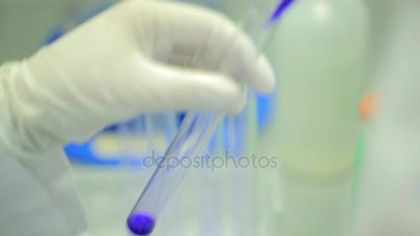 Test tubes closeup. Medical equipment. Close-up footage of a scientist using a micro pipette in a laboratory. Laboratory technician injecting liquid into a microtiter plate. Test tubes. Small depth of — Stock Video