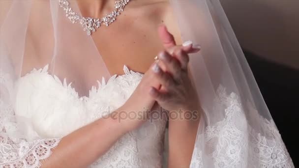 Bride with flowers in hand outdoors. The bride is nervous before the wedding. Bride holding a perfume. nice wedding bouquet in brides hand. Bride is holding beautiful bright wedding bouquet. the — Stock Video