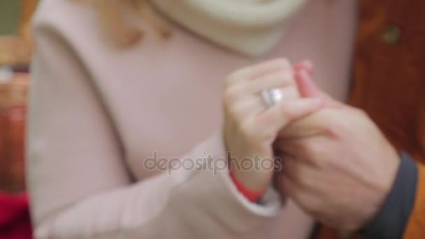 Newly married couple holding hands. Young couple in love walking in the autumn park holding hands. Lovers in the park — Stock Video