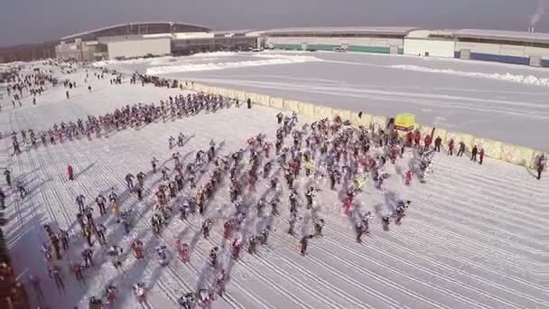 Участники массовой лыжной гонки "Лыжня России" во время соревнований. соревнование на лыжах, толпа. большое количество людей, принимающих участие в соревнованиях на склонах — стоковое видео