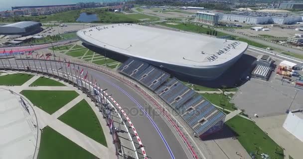 The formula 1 track in Sochi, the Olympic village in Sochi. Building site of stadium for racing near town and mountains at summer sunny day. Aerial view. Aerrial view on pectator stands F1 Russian — Stock Video