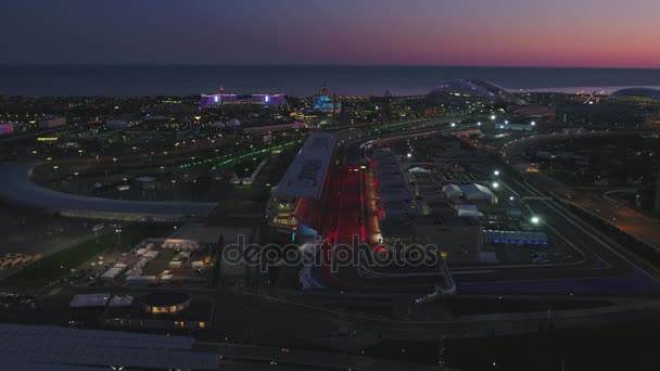 Antenowe Olimpic Vilage, Sochi, Federacja Rosyjska. Wioski olimpijskiej w Soczi w nocy. Niesamowite perspektywy czysto Bogatyr, toru Formuły 1, stadion fischt budynku backlighted przez różne — Wideo stockowe