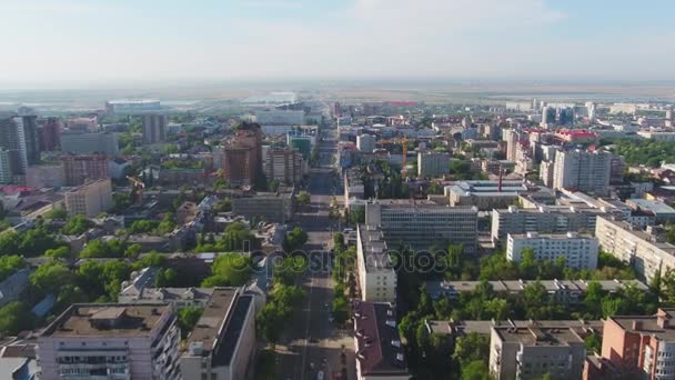 Aerial city view with crossroads and roads, houses, buildings, parks and parking lots, bridges. Urban landscape. Copter shot. Panoramic. View from the sky on city in summer day — Stock Video