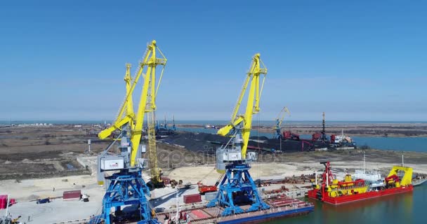 Aerial loading the Containers by crane , Trade Port , Shipping. Cranes for loading, unloading and sorting of containers. Container Cargo freight ship with working crane bridge in shipyard at dusk for — Stock Video