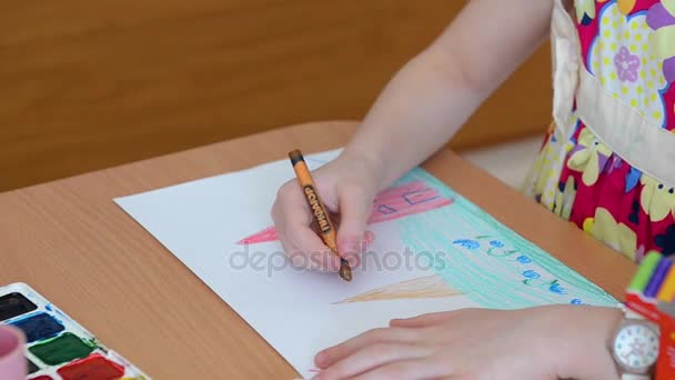 Child hand is drawing with colorful pencils. Drawing pencils, children learn about the world, draw houses, trees, sun — Stock Video