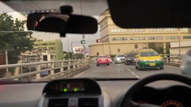 BANGKOK - 9 de junio: Vista de la autopista desde el asiento del pasajero en taxi. Panel de control del coche y parabrisas húmedo de una fuerte lluvia en un tráfico pesado en Bangkok, Tailandia. Bangkok vista desde un taxi — Vídeo de stock