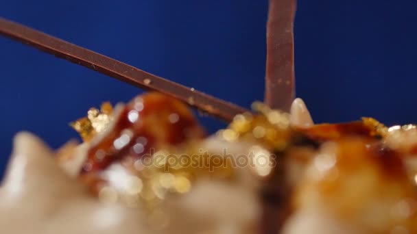 Chocolate cupcake with chocolate mousse cream brown blue background. Tasty cake with cream, closeup — Stock Video