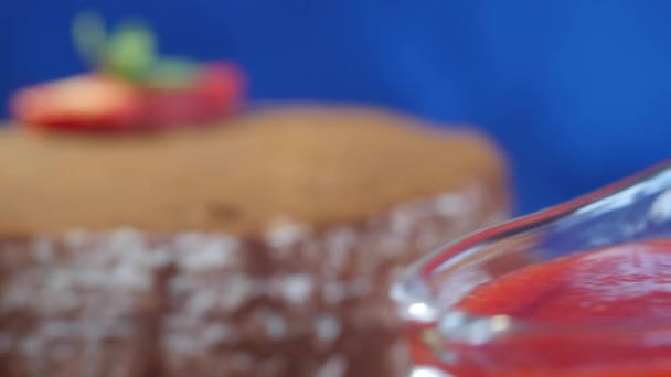 Gros plan du gâteau au chocolat fait maison avec des fraises sur fond bleu foncé. Dessert au chocolat. Gâteau aux fraises fraîches avec garniture au chocolat sur une table — Video