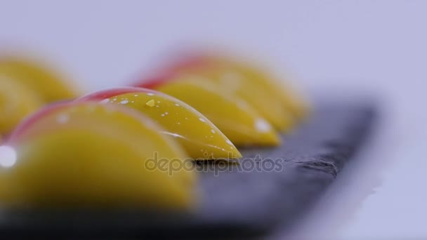 Primer plano de dos caramelos sobre fondo blanco. Trozos de caramelo salado. Fila de caramelos sobre fondo blanco — Vídeos de Stock