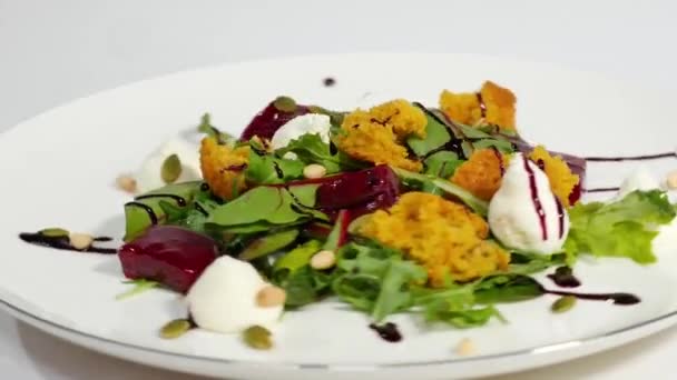 Salad with herring, beetroot, paprika, red onion, mustard and balsamic vinegar. Salad of lettuce, beetroot and salmon fillets with a delicate cream sauce. Salad with greens, fish and beetroot — Stock Video