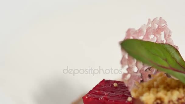 Beetroot salad. Salad with roasted beetroot, spinach, soft goat cheese and seeds in light plate over grey concrete textured background, oil in saucer. Top view — Stock Video