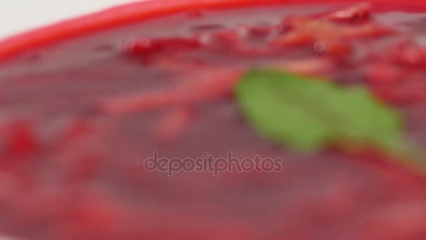 Ukrainian and russian national food - red beet soup borscht with beef.Moldovan soup. Close up. plate of beetroot cream soup on checkered dishtowel. Russian national food, red beet soup, borscht — Stock Video