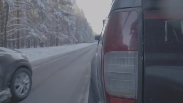 Rear lamp SUV on winter road, red light. Close up of Big Black Car from Rear View on a winter road — Stock Video