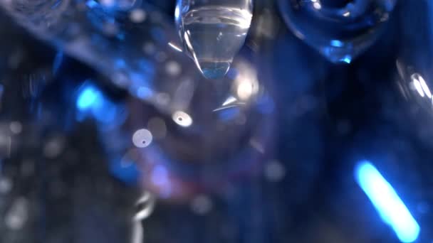 Closeup of melting icicle with a hanging drop. Frozen icicle with drop of water in macro. Melting icicles with water drops — Stock Video