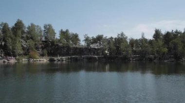 Nehir kıyısında eğlence parkı. Dönme dolap, mavi gökyüzü ve nehir. Büyük dönme dolap ile Park