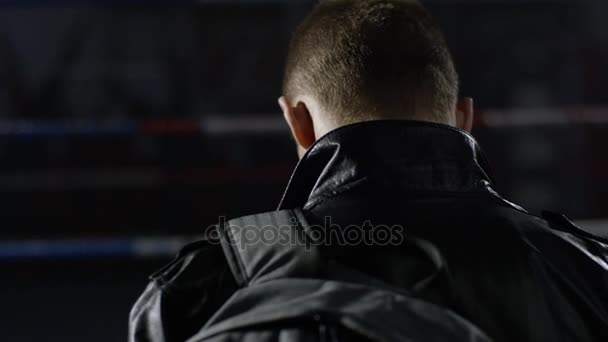 Back view of traveling handsome man in jacket with suitcas looking up. Rear view people collection. backside view of person. Man in a jacket and bag back view black background — Stock Video