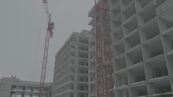 Apartments construction site with crane. Crane and building construction — Stock Video