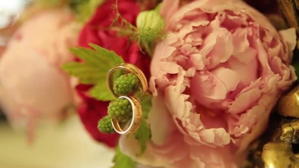 结婚戒指和粉红玫瑰花束。婚礼花束上的结婚戒指。结婚戒指上一束玫瑰. — 图库视频影像