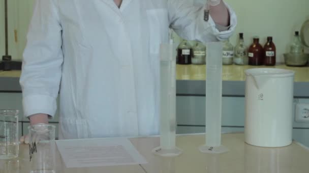 Γκρο πλαν μερική άποψη των επιστημόνων κάνει πείραμα με αντιδραστήριο και φιάλες. κοντινό πλάνο της βιοτεχνολογικής έρευνας στο εργαστήριο — Αρχείο Βίντεο