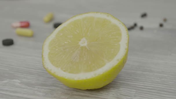 One half of a ripe yellow lemon on the table. One sliced lemon is on the table — Stock Video