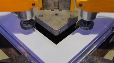 Kaynak Makinası fabrikasında çalışan işçi. PVC pencere Kaynak Makinası. Alüminyum pencere çerçeve basın makine. Çalışan bir pencere plastik üretir. Tehlike işareti ile endüstriyel basın yakın çekim.