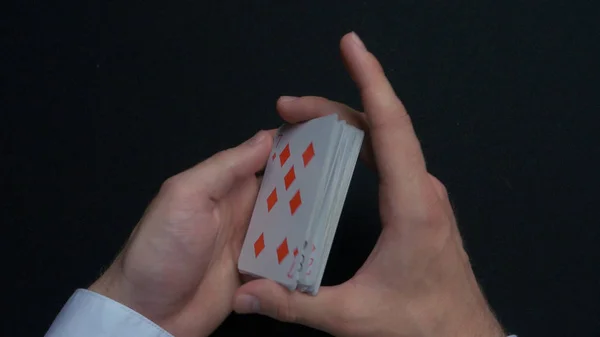 Poker game - shuffling cards. Mans hands shuffing cards. Close up. Mans hands shuffling playing cards. Dealers hands shuffling cards during a poker game — Stock Photo, Image