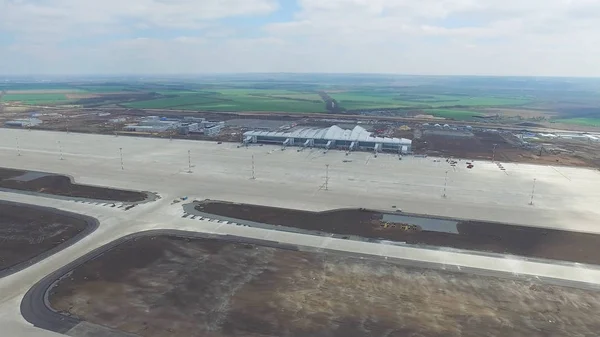 Aerial view of terminals and tower. Aerial view of the Air park near Krakow city center. Airport terminal, air crafts, roads, buildings. Aerial view of the Air park near city center. Airport terminal