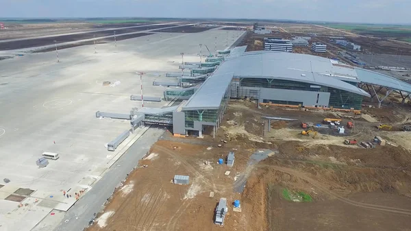 The construction of the airport with runway. Aerial view of Airport runway become a construction site. workers build the new airport and special equipment. Airport construction and Sky with Clouds