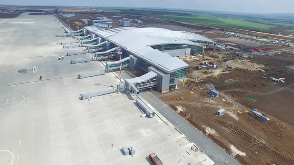 The construction of the airport with runway. Aerial view of Airport runway become a construction site. workers build the new airport and special equipment. Airport construction and Sky with Clouds