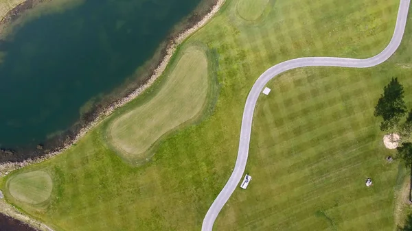 Carro de golfe solar com nuvens no céu azul e floresta lago Golf Club, aéreo — Fotografia de Stock