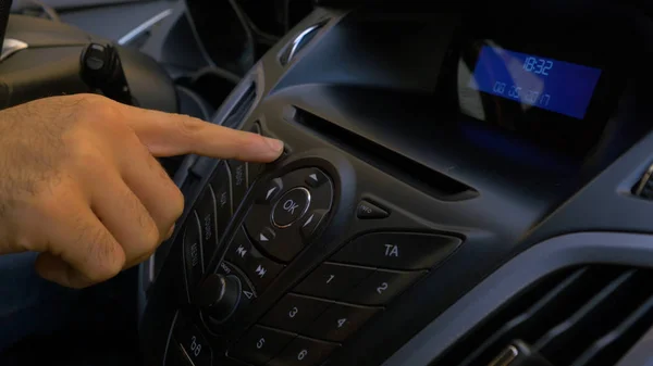 Mans main met le disque dans le lecteur de voiture. Commande de bouton pour lecteur de disque compact dans une voiture. Main met le disque dans la voiture radio — Photo