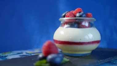 Ev yapımı yoğurt bir cam kavanoza yaban mersini ile. Çilekli yoğurt, yakın çekim.