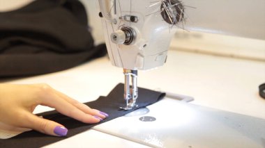 Dikiş makinesi, dikiş makinesi ve kadın boyuyla terzi. Antika dikiş makinesi Franklin. Genç kadın dikiş makinesi üzerinde çalışan koruyucu yüz maskesi takıyor. Moda