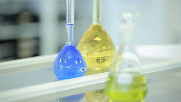 Χημική φιάλες με υγρό πράσινο και μπλε σε άσπρο φόντο. Δοκιμή-σωλήνων με πολύχρωμα χημικό αντιδραστήριο. Φαρμακευτικός και εργαστηριακός εξοπλισμός. Χημικό εργαστήριο. Επιλεκτική cocus. Bokeh. επιστήμονας και την ιατρική — Φωτογραφία Αρχείου