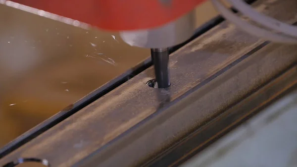 Hole being drilled into metal. Drilling closeup in metal workshop. Employee drill in flat steel plate with bench drill. Industry in slow motion — Stock Photo, Image