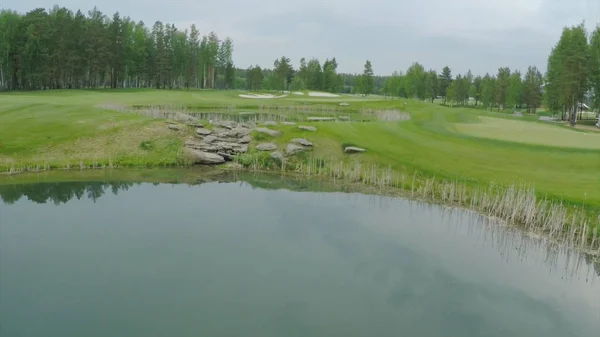 Top view green golf course outdoor green grass field. Aerial view from flying drone