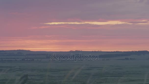 Beautiful sunrise with stars and galaxy in night sky. Field, sunrise and blue sky. Green grass on a background beautiful sunset or sunrise — Stock Video