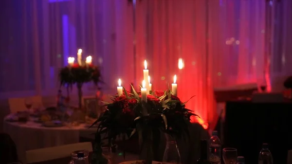 Encender una vela con una cerilla para conseguir una vela romántica. Increíbles andles y candelabros están sobre la mesa. Mantenga las luces con el trasfondo pacífico de la ceremonia religiosa . — Foto de Stock