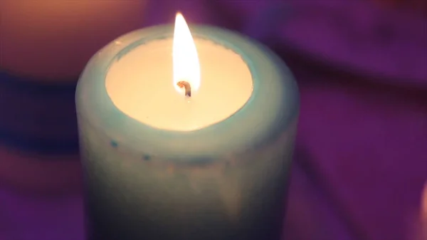 Lighting A Candle With A Match To Get A Romantic Candlelight. Amazing andles and candlesticks are on the table. Stay lights with the peaceful background of religious ceremony. — Stock Photo, Image