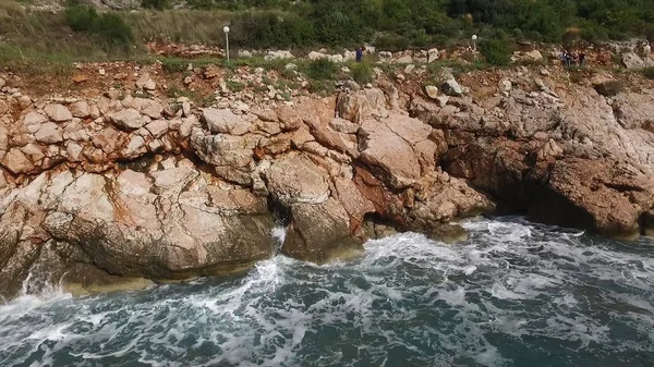 Vågorna bryta på en stenig strand, bildar en spray. Footage. Stänkande vågor på klipporna över havet — Stockfoto