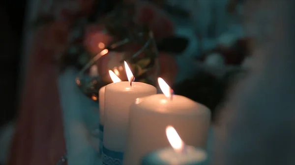 Lighting A Candle With A Match To Get A Romantic Candlelight. Amazing andles and candlesticks are on the table. Stay lights with the peaceful background of religious ceremony. — Stock Photo, Image