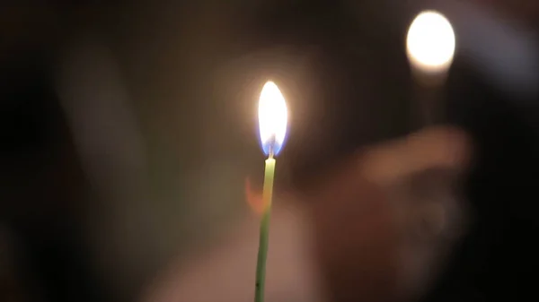 Lighting A Candle With A Match To Get A Romantic Candlelight. Amazing andles and candlesticks are on the table. Stay lights with the peaceful background of religious ceremony. — Stock Photo, Image