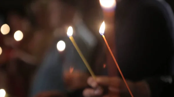 Lighting A Candle With A Match To Get A Romantic Candlelight. Amazing andles and candlesticks are on the table. Stay lights with the peaceful background of religious ceremony. — Stock Photo, Image