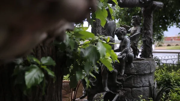 Fountain. Garden statue vintage close-up. Sleeping Angel at La Recoleta Cemetery in Buenos Aires. Garden sculpture. Cupid sculpture. Sculpture of Angel at a Prague cemetery. Statue — Stock Photo, Image