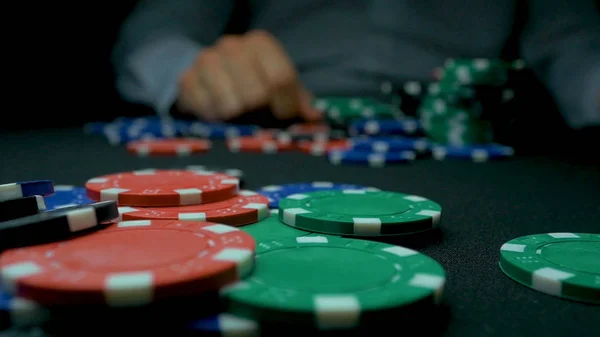 Rzucać blue chipy w pokera. Niebieski i czerwony gra Poker Chips w My lšcy czarne tło. Zbliżenie Poker chips w stosy na powierzchni stołu zielonej karty filcu w zwolnionym tempie — Zdjęcie stockowe